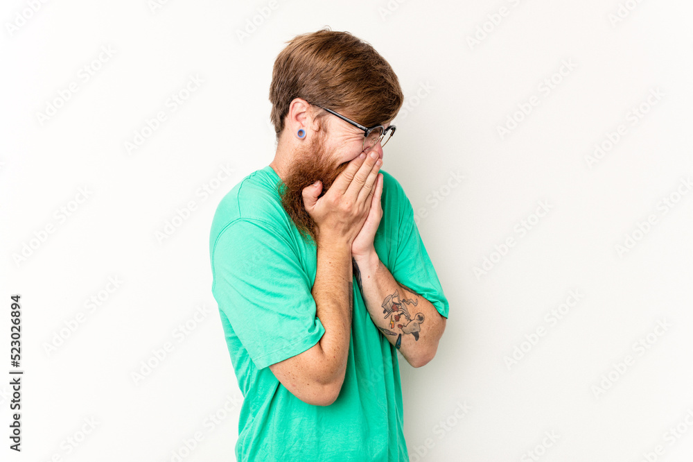 Young caucasian red-haired man isolated on white background laughing about something, covering mouth with hands. Young caucasian red-haired man isolated on white background laughing about something, covering mouth with hands.