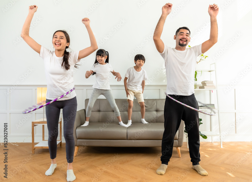 Young  asian parents with child meditating at home isolated in room.  Family, sport, yoga concept.