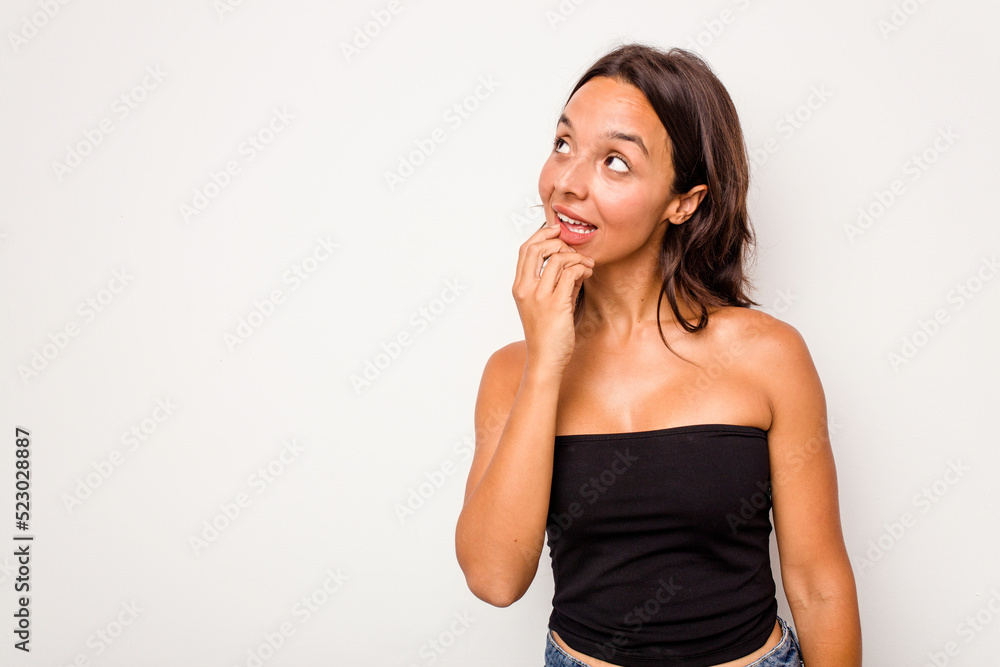 Young hispanic woman isolated on white background relaxed thinking about something looking at a copy space. Young hispanic woman isolated on white background relaxed thinking about something looking at a copy space.
