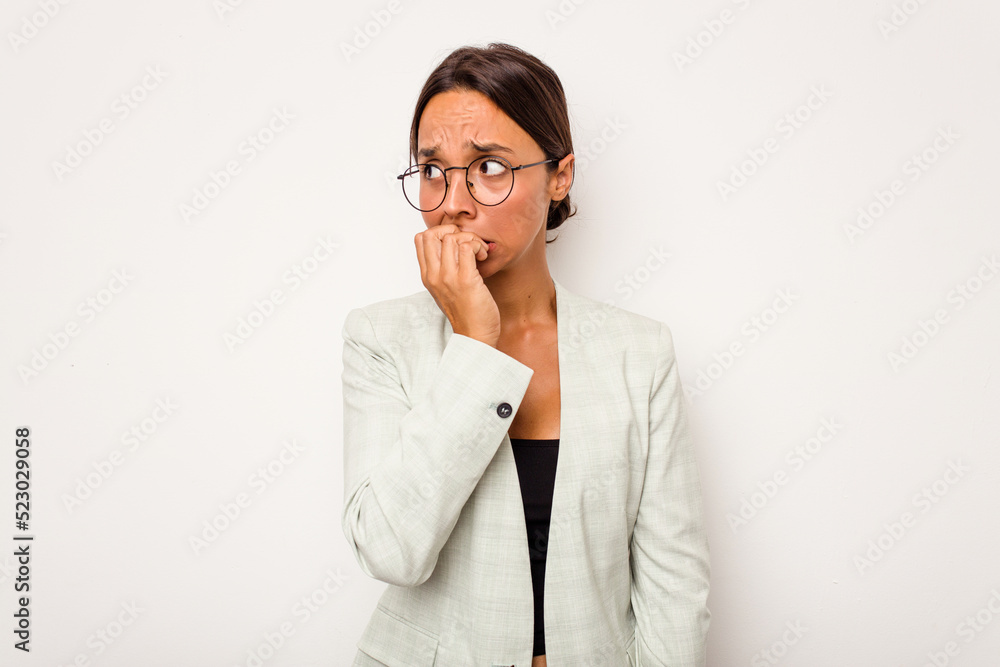 Young hispanic woman isolated on white background biting fingernails, nervous and very anxious.