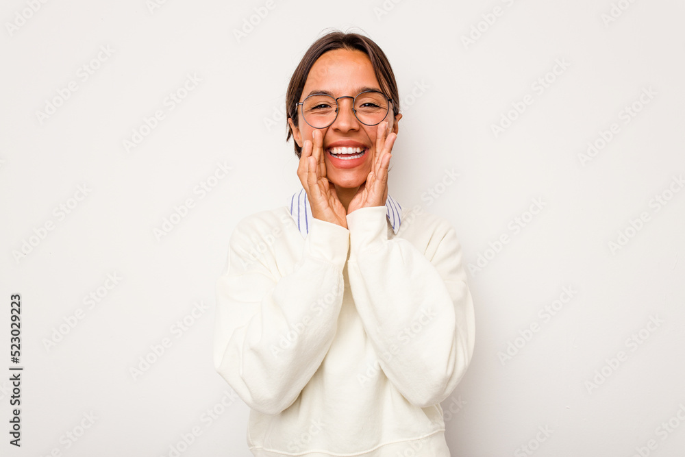 Young hispanic woman isolated on white background saying a gossip, pointing to side reporting something. Young hispanic woman isolated on white background saying a gossip, pointing to side reporting something.