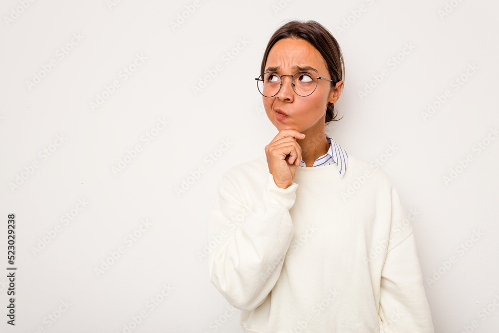 Young hispanic woman isolated on white background looking sideways with doubtful and skeptical expression. Young hispanic woman isolated on white background looking sideways with doubtful and skeptical expression.