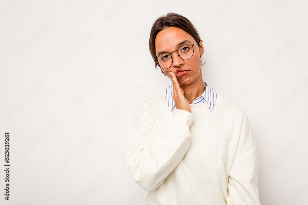 Young hispanic woman isolated on white background who feels sad and pensive, looking at copy space. Young hispanic woman isolated on white background who feels sad and pensive, looking at copy space.