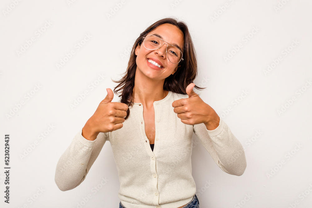 Young hispanic woman isolated on white background raising both thumbs up, smiling and confident. Young hispanic woman isolated on white background raising both thumbs up, smiling and confident.
