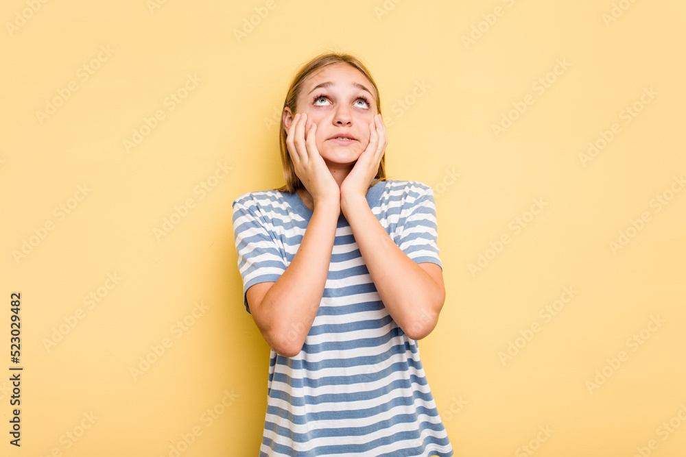 Young caucasian girl isolated on yellow background whining and crying disconsolately. Young caucasian girl isolated on yellow background whining and crying disconsolately.