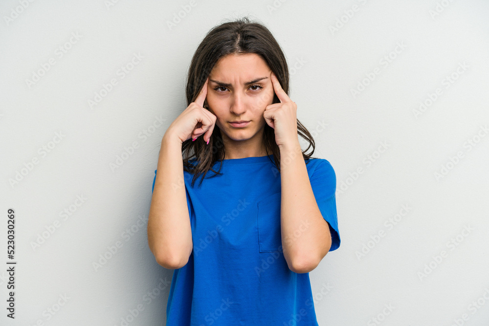 Young caucasian woman isolated on white background focused on a task, keeping forefingers pointing head. Young caucasian woman isolated on white background focused on a task, keeping forefingers pointing head.