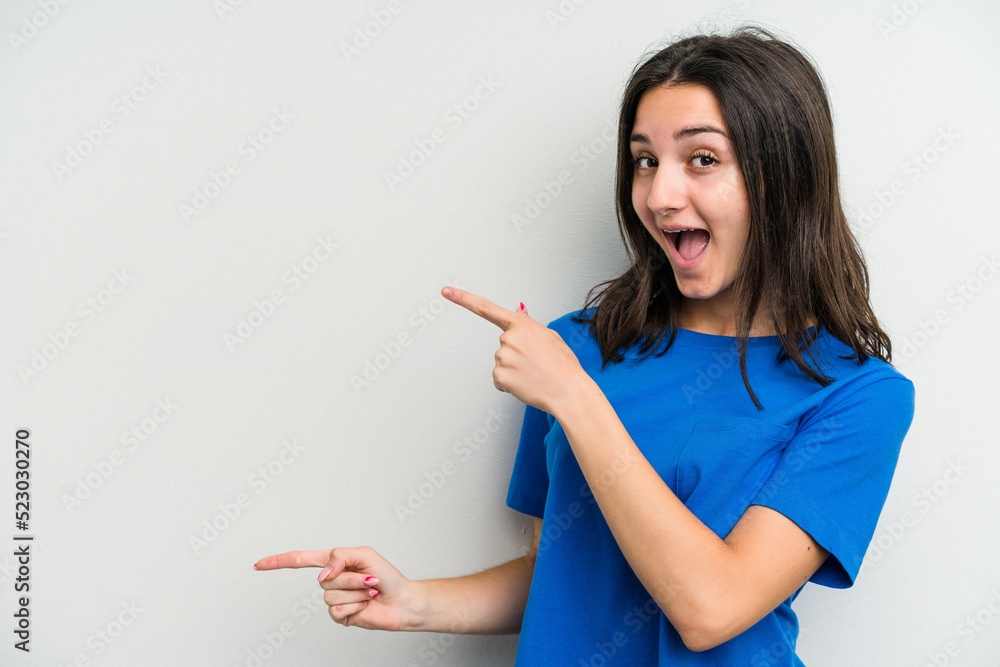 Young caucasian woman isolated on white background pointing with forefingers to a copy space, expressing excitement and desire. Young caucasian woman isolated on white background pointing with forefingers to a copy space, expressing excitement and desire.
