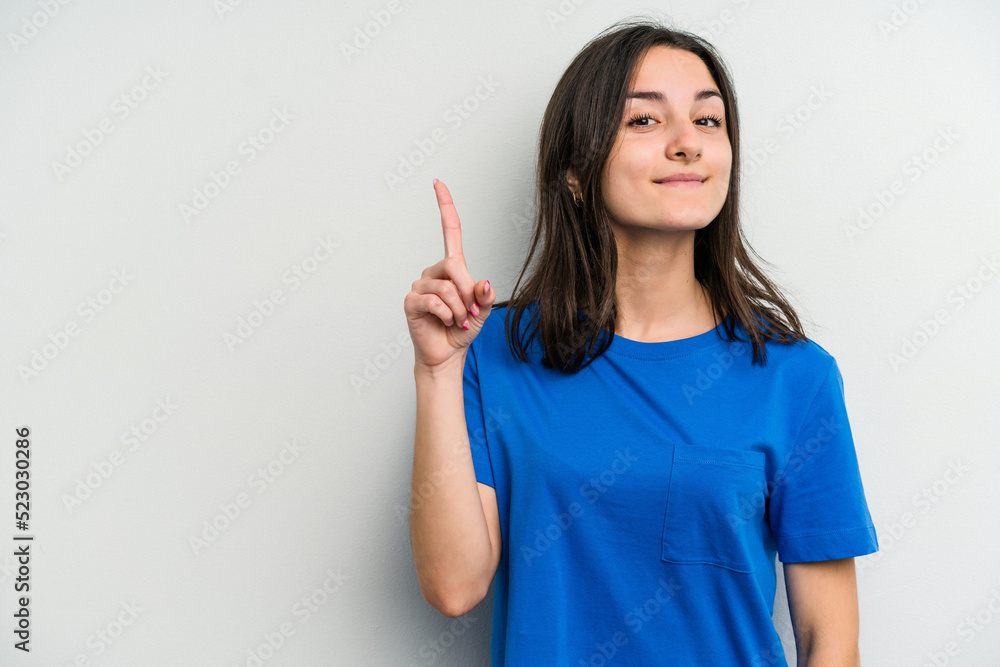 Young caucasian woman isolated on white background showing number one with finger. Young caucasian woman isolated on white background showing number one with finger.