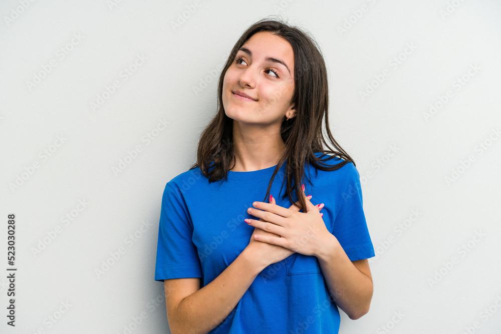 Young caucasian woman isolated on white background has friendly expression, pressing palm to chest. Love concept. Young caucasian woman isolated on white background has friendly expression, pressing palm to chest. Love concept.