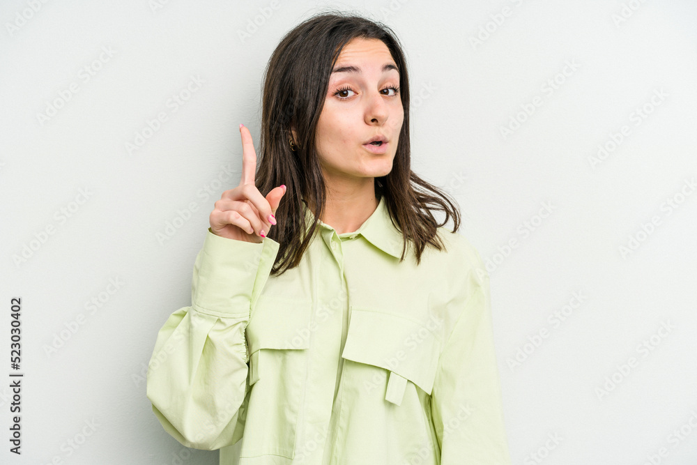 Young caucasian woman isolated on white background pointing upside with opened mouth. Young caucasian woman isolated on white background pointing upside with opened mouth.