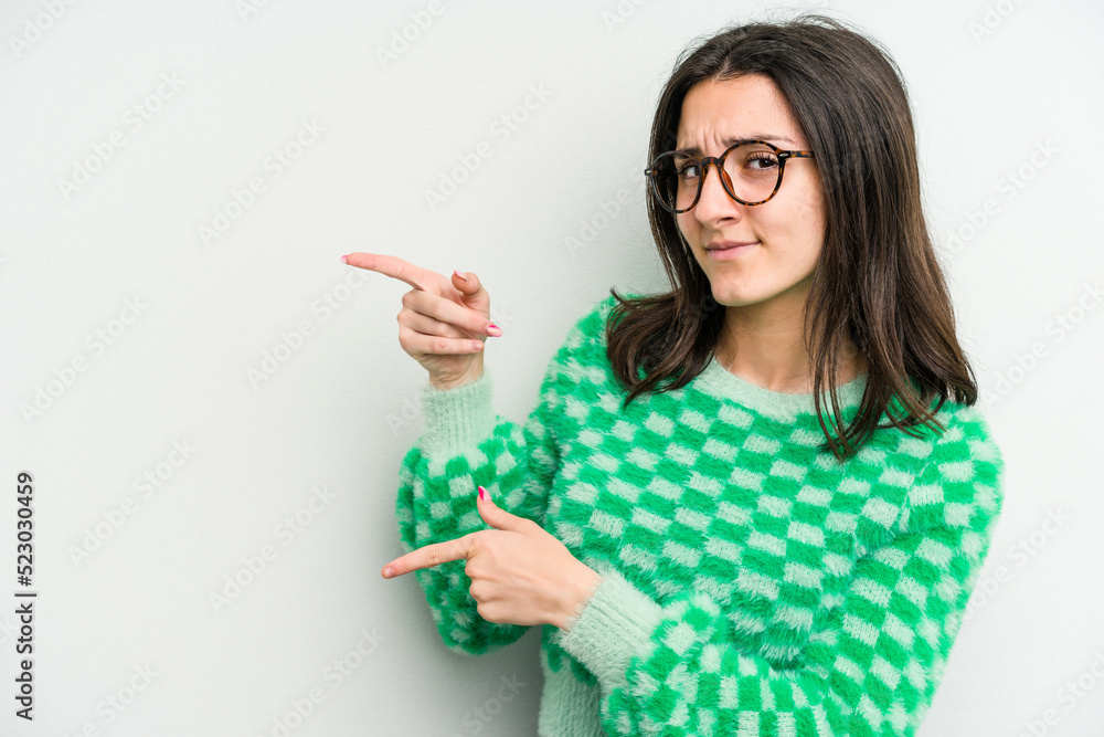 Young caucasian woman isolated on white background shocked pointing with index fingers to a copy space. Young caucasian woman isolated on white background shocked pointing with index fingers to a copy space.