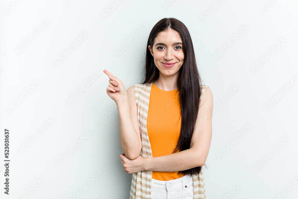 Young caucasian woman isolated on white background smiling cheerfully pointing with forefinger away. Young caucasian woman isolated on white background smiling cheerfully pointing with forefinger away.
