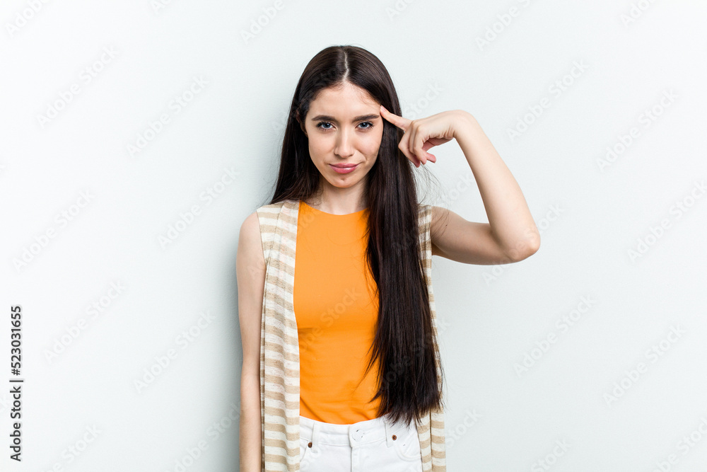 Young caucasian woman isolated on white background pointing temple with finger, thinking, focused on a task. Young caucasian woman isolated on white background pointing temple with finger, thinking, focused on a task.