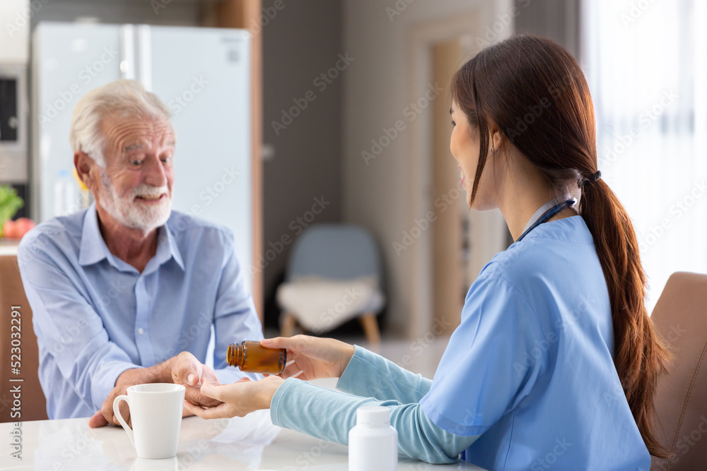 Obraz premium happy senior retire adult take a pill or drug for treatment by young female doctor from clinic hospital to takecare for health at home