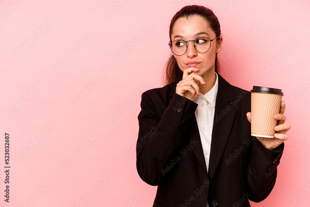 Young business caucasian woman holding take away coffee isolated on pink background looking sideways with doubtful and skeptical expression. Young business caucasian woman holding take away coffee isolated on pink background looking sideways with doubtful and skeptical expression.