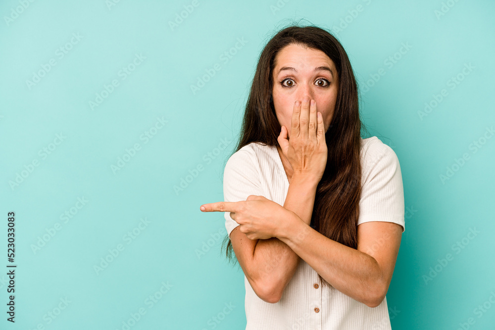 Young caucasian woman isolated on blue background pointing to the side Young caucasian woman isolated on blue background pointing to the side