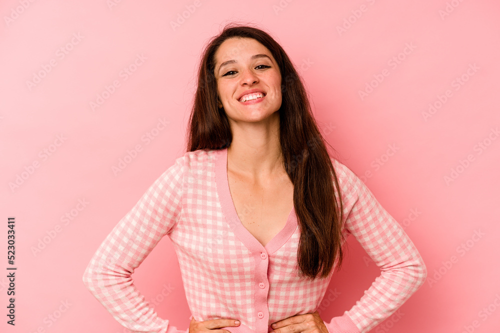 Young caucasian woman isolated on pink background confident keeping hands on hips. Young caucasian woman isolated on pink background confident keeping hands on hips.