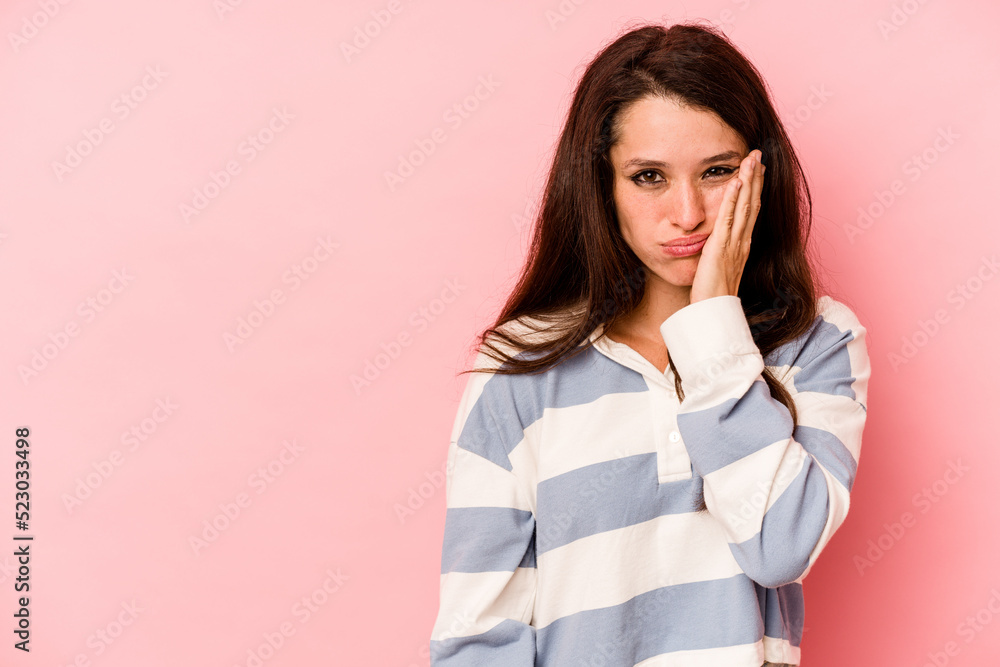 Young caucasian woman isolated on pink background who feels sad and pensive, looking at copy space. Young caucasian woman isolated on pink background who feels sad and pensive, looking at copy space.