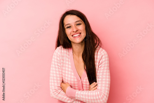 Young caucasian woman isolated on pink background laughing and having fun.