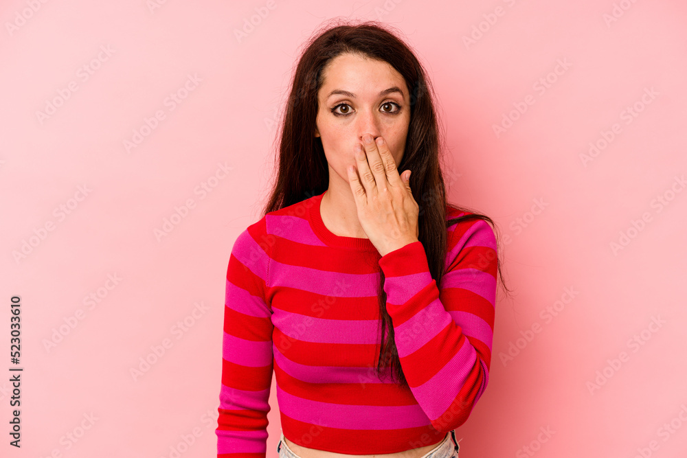 Young caucasian woman isolated on pink background shocked, covering mouth with hands, anxious to discover something new. Young caucasian woman isolated on pink background shocked, covering mouth with hands, anxious to discover something new.
