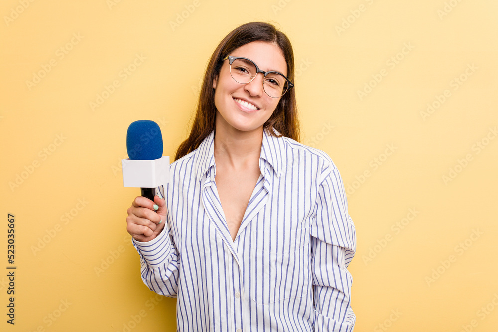 Young caucasian presenter TV woman isolated on yellow background happy, smiling and cheerful. Young caucasian presenter TV woman isolated on yellow background happy, smiling and cheerful.