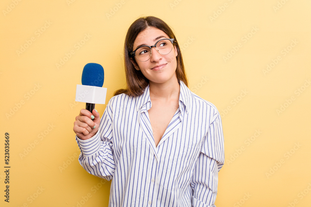 Young caucasian presenter TV woman isolated on yellow background dreaming of achieving goals and purposes Young caucasian presenter TV woman isolated on yellow background dreaming of achieving goals and purposes