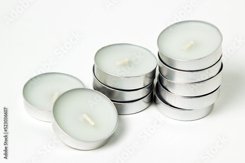 Tableau sur toile Tea candles on a white background. Set of tea lights.