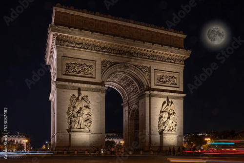 Paris, France - 08 12 2022: Place Charles de Gaulle. L'Arc de Triomphe with the super moon by night