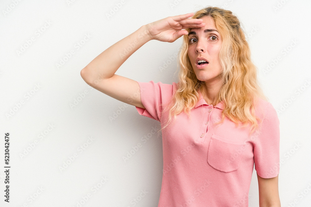 Young caucasian woman isolated on white background looking far away keeping hand on forehead. Young caucasian woman isolated on white background looking far away keeping hand on forehead.