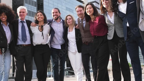 Group of business people together smiling outdoors in financial district