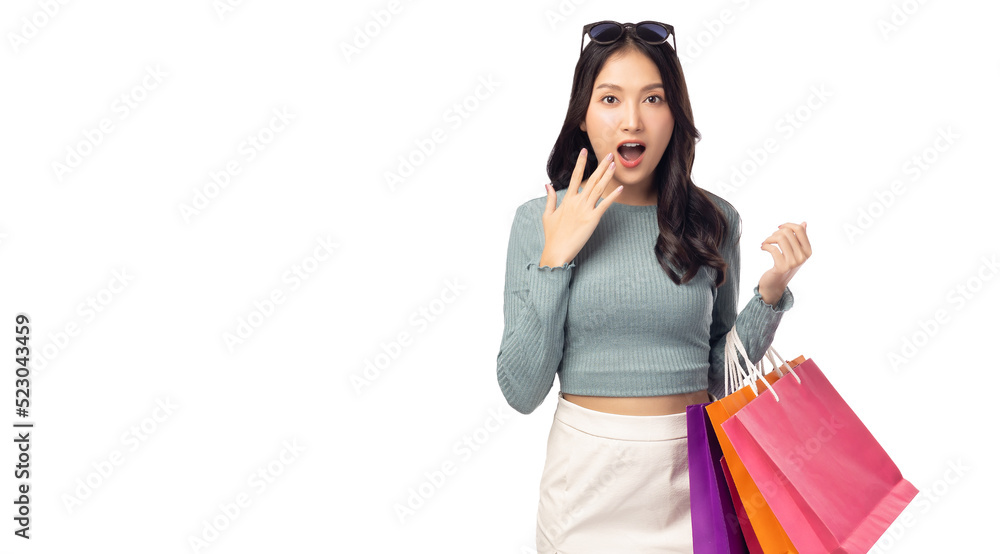 Excited beautiful young woman wearing sunglasses hold shopping bags isolated on white background and copy space Surprise happy asian girl open mouth with excited Beauty young female love shopping Excited beautiful young woman wearing sunglasses hold shopping bags isolated on white background and copy space Surprise happy asian girl open mouth with excited Beauty young female love shopping