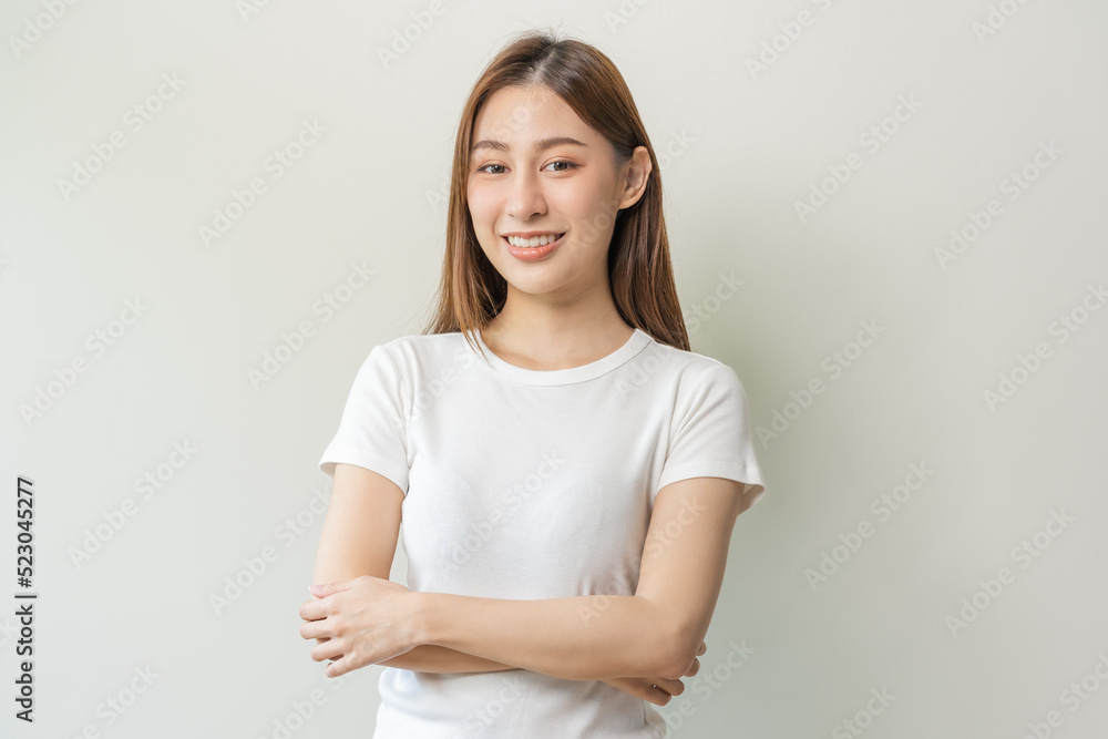 Smile positive, attractive asian young woman wearing casual, portrait of beautiful brunette her with long hair, feeling happy looking at camera, standing cross arms chest isolated on white background. Smile positive, attractive asian young woman wearing casual, portrait of beautiful brunette her with long hair, feeling happy looking at camera, standing cross arms chest isolated on white background.