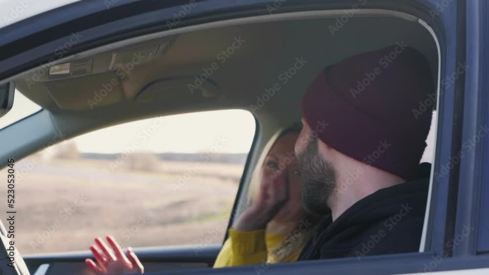 The happy couple is talking in the car The happy couple is talking in the car