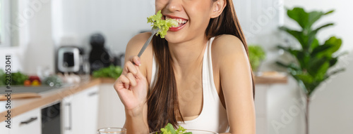 Bilde på lerret Smiled happy woman eating a bowl of salad as breakfast for good health