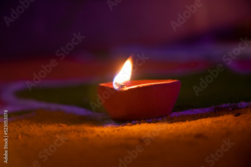 Photography Close-Up Of Illuminated Diya On Rangoli during diwali festival