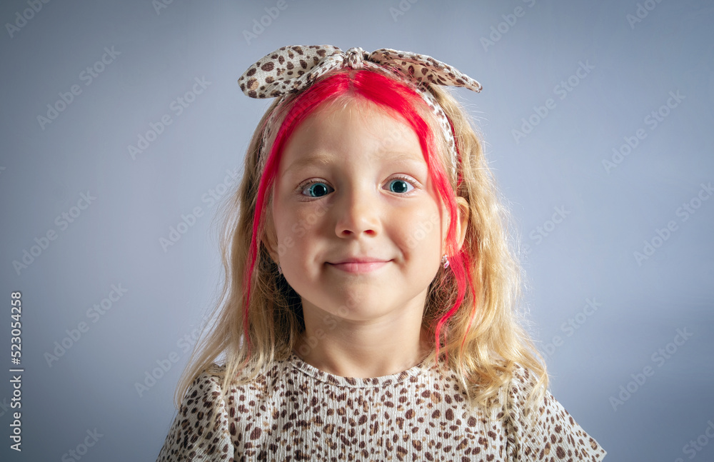 Cute caucasian little girl wearing headband portrait on gray background. Studio head shot copy space. Cute caucasian little girl wearing headband portrait on gray background. Studio head shot copy space.