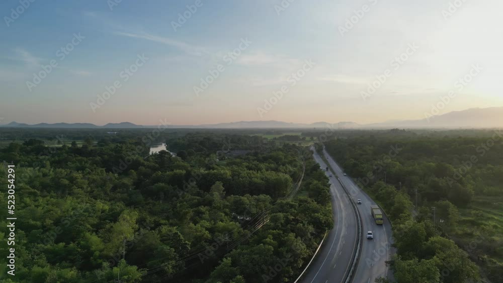 4K Video aerial shot of road riding along road in green forest. Concept for country transportation and sustainable. 4K Video aerial shot of road riding along road in green forest. Concept for country transportation and sustainable.