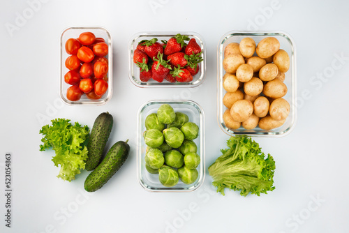Glass boxes with fresh raw vegetables. Vegetables and fruits in glass containers. Food storage concept