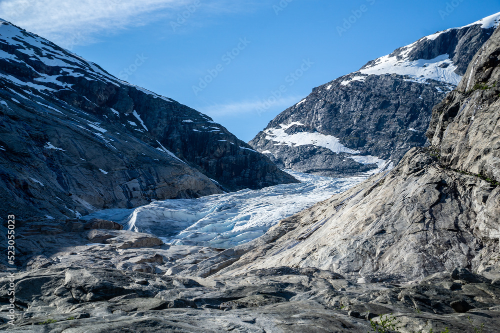 Fototapeta premium Part of the Nigardsbreen glacier surrounded by high snow capped mountains
