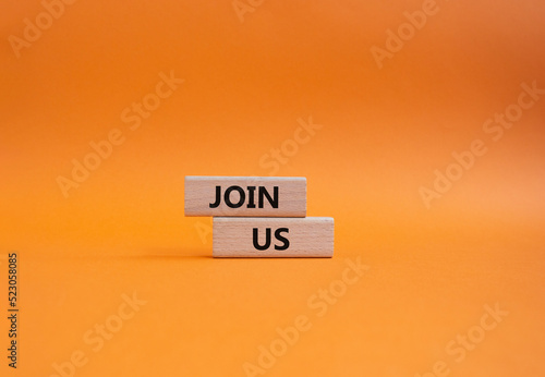 Join us symbol. Concept word Join us on wooden blocks. Beautiful orange background. Business and Join us concept. Copy space