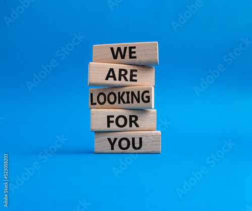 Tell us what you think symbol. Wooden blocks with words Tell us what you think. Beautiful blue background. Businessman hand. Business and Tell us what you think concept. Copy space.