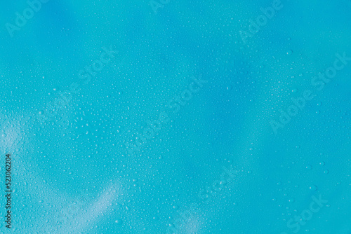 Empty blue background with water drops. Marine backdrop with copy space