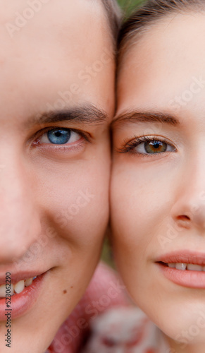 Close up portrait of man and woman. Face to face  half face. Male has blue eye and female has green eye. Genetics  generation concept.