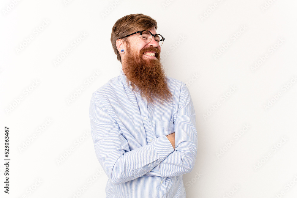 Young caucasian red-haired man isolated on white background laughing and having fun. Young caucasian red-haired man isolated on white background laughing and having fun.