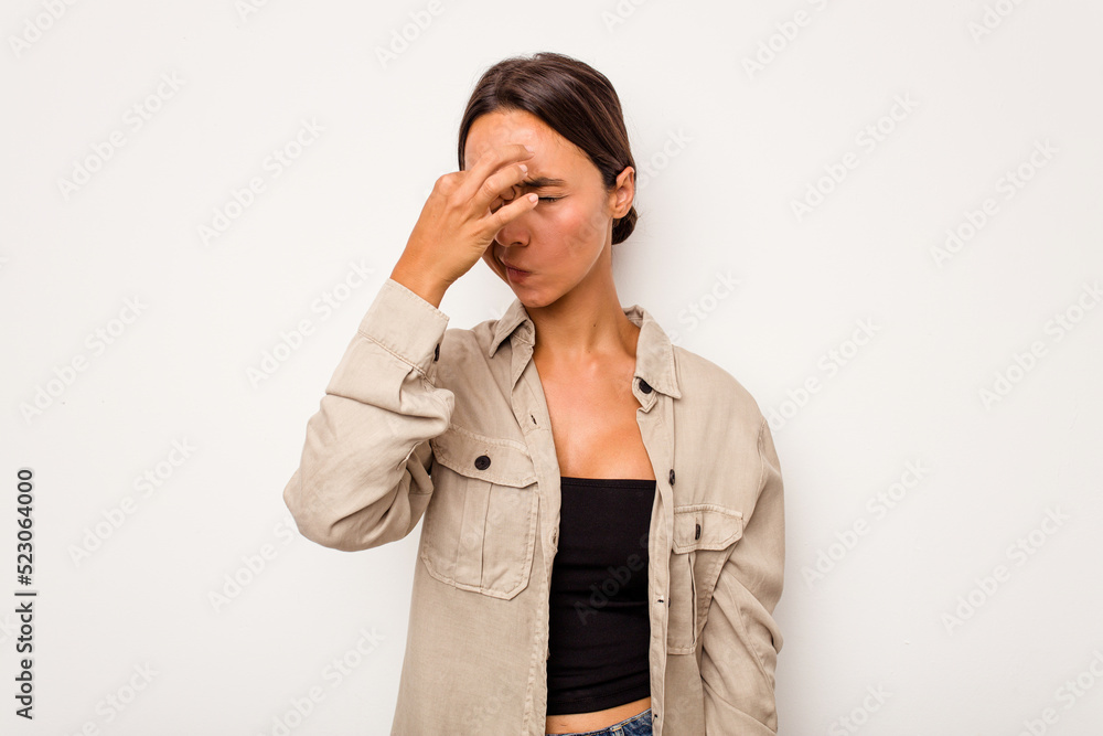 Young hispanic woman isolated on white background having a head ache, touching front of the face. Young hispanic woman isolated on white background having a head ache, touching front of the face.