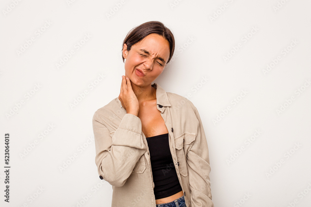 Young hispanic woman isolated on white background having a neck pain due to stress, massaging and touching it with hand. Young hispanic woman isolated on white background having a neck pain due to stress, massaging and touching it with hand.