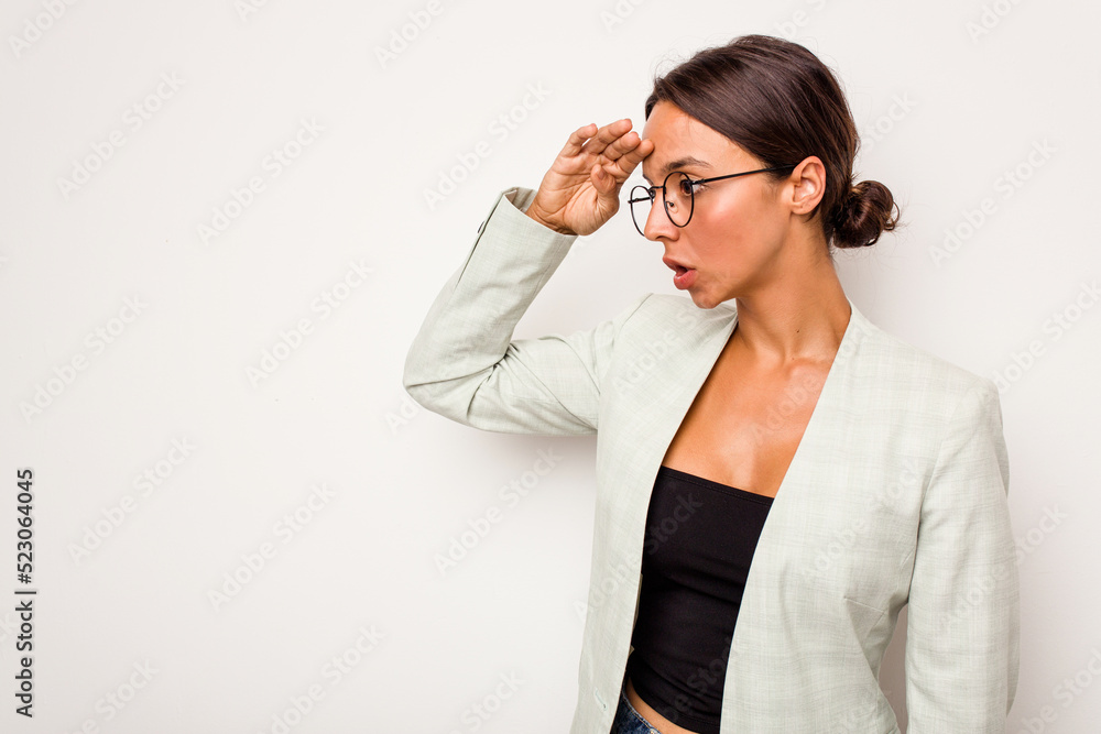 Young hispanic woman isolated on white background looking far away keeping hand on forehead. Young hispanic woman isolated on white background looking far away keeping hand on forehead.