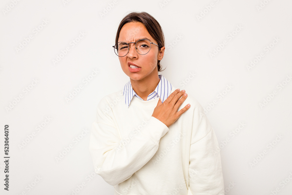 Young hispanic woman isolated on white background having a shoulder pain. Young hispanic woman isolated on white background having a shoulder pain.