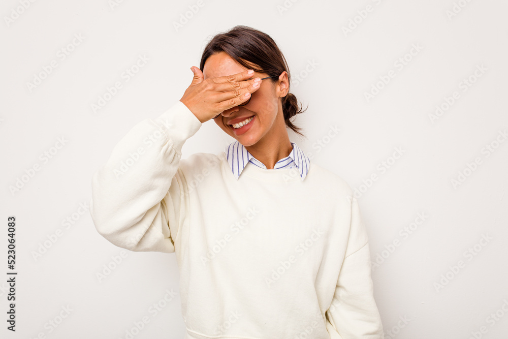 Young hispanic woman isolated on white background covers eyes with hands, smiles broadly waiting for a surprise. Young hispanic woman isolated on white background covers eyes with hands, smiles broadly waiting for a surprise.