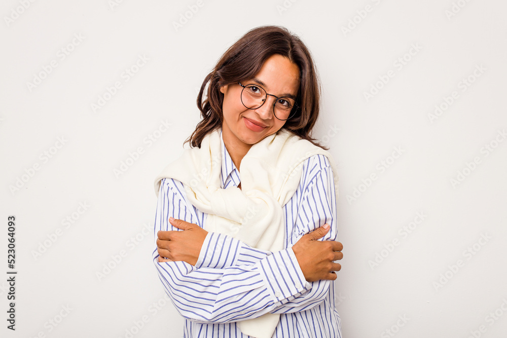 Young hispanic woman isolated on white background hugs, smiling carefree and happy. Young hispanic woman isolated on white background hugs, smiling carefree and happy.